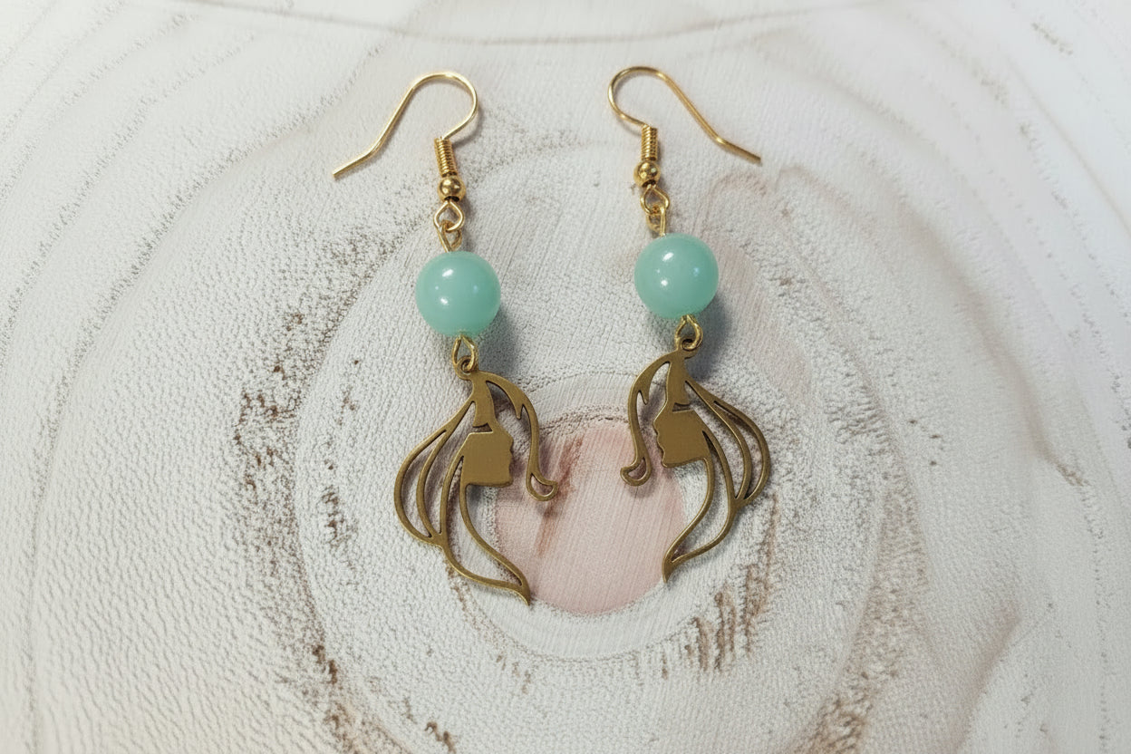 boucles d’oreilles visage, pendentif visage, acier inoxydable hypoallergénique, bijou jade, bijou corail, boucles d’oreilles doré, boucles d’oreilles argenté, bijoux légers, bijou artistique, accessoire femme, style élégant, cadeau femme, bijou quotidien, tendance 2026, bijou minimaliste, bijou visage